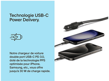 Charger l'image dans la galerie, Un chargeur de voiture noir avec deux câbles et deux téléphones en charge.