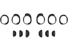 Charger l'image dans la galerie, Embouts d'oreille noirs et un bandeau noir, composants d'un casque, disposés sur une surface blanche.