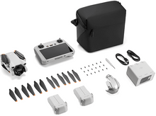 Charger l'image dans la galerie, Un kit de drone posé sur une surface blanche, avec drone, chargeur et télécommande.
