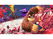 Charger l'image dans la galerie, Donkey Kong dans une scène de jeu vidéo, avec un ennemi violet et des objets rouges explosant.