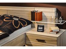 Charger l'image dans la galerie, Une scène de chambre avec un lit, des livres, une horloge, des flacons de parfum et une table de chevet.