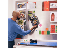 Charger l'image dans la galerie, Une personne aux cheveux blonds courts, un tatouage et une boucle d'oreille regarde la caméra.