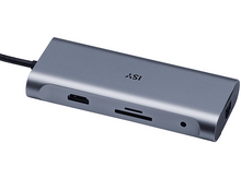 Charger l'image dans la galerie, Un hub USB gris avec plusieurs ports, vu légèrement en biais, sur une surface blanche.