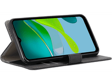 Charger l'image dans la galerie, Téléphone dans un étui portefeuille, affichant un écran avec un design abstrait vert et bleu.