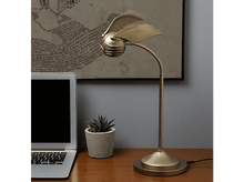 Charger l'image dans la galerie, Une lampe Vif d'or dorée sur un bureau, avec un ordinateur portable et une petite plante.