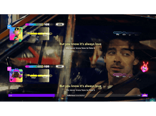 Charger l'image dans la galerie, Deux chanteurs dans une voiture, chantant des paroles. L'un a un avatar coloré, l'autre est un homme.