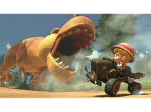 Charger l'image dans la galerie, Un personnage de dessin animé fait la course avec un kart tandis qu'un dinosaure poursuit.
