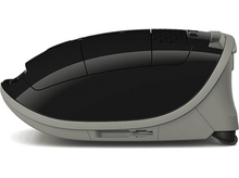 Charger l'image dans la galerie, Un aspirateur robot noir et gris, vue latérale.