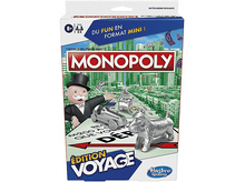 Charger l'image dans la galerie, Une boîte de jeu de société Monopoly avec une scène de ville et des pions.