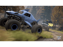Charger l'image dans la galerie, Monster truck sur le thème du requin, "Megalodon", roulant sur une piste de terre. Un autre camion en arrière-plan.