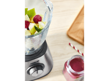 Charger l'image dans la galerie, Mixeur avec des fruits, framboises et tranches de pomme. Pot de liquide rouge et paille.