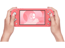Charger l'image dans la galerie, Une console portable Nintendo Switch Lite de couleur corail, tenue par deux mains.