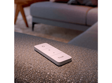 Charger l'image dans la galerie, Une télécommande Hue blanche sur une surface à motifs.