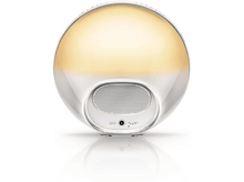 Charger l'image dans la galerie, Un réveil circulaire blanc et doré avec un reflet. Il possède un haut-parleur et une entrée d'alimentation.