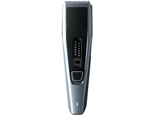 Charger l'image dans la galerie, Une tondeuse à cheveux Philips bleue et noire avec différents réglages de longueur.