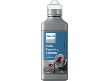 Charger l'image dans la galerie, Bouteille de détachant Philips, avec une tache sur un canapé. Le texte dit 'Stain Removing Solution'.