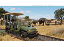 Charger l'image dans la galerie, Un jeep de safari sur une piste avec des gens, des éléphants et des arbres dans un zoo.