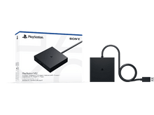 Charger l'image dans la galerie, PlayStation VR2 avec adaptateur et boîte sur fond noir. Appareil carré noir.