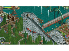 Charger l'image dans la galerie, Des montagnes russes avec des wagons rouges grimpent et descendent dans un parc.