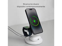 Charger l'image dans la galerie, Une station de recharge avec un téléphone, une montre et des écouteurs. Le téléphone et la montre affichent la recharge.