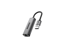 Charger l'image dans la galerie, Un adaptateur USB vers Ethernet Sitecom gris est présenté sur fond noir.