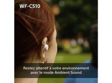 Charger l'image dans la galerie, Une personne avec des écouteurs blancs, portant des boucles d'oreilles, et un arrière-plan flou d'arbres.