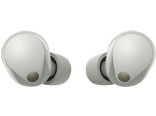 Charger l'image dans la galerie, Deux écouteurs blancs avec des accents dorés, vus d'une perspective rapprochée.