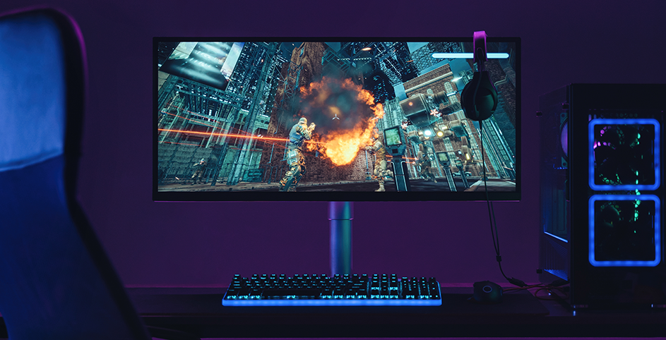 Un bureau sur lequel est posé un écran gamer, un clavier gamer et un PC gamer.
