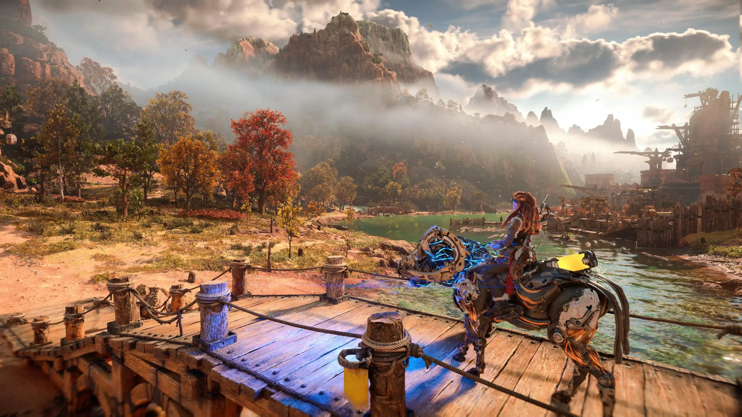 Aloy chevauche une monture mécanique face à des montagnes imposantes dans Horizon Forbidden West.