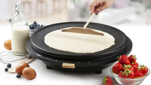 Une crêpière DOMO et un bol de fraises.