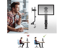 Charger l&#39;image dans la galerie, Homme travaillant sur un ordinateur, à côté d&#39;un support d&#39;écran et de schémas.
