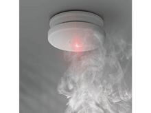 Charger l&#39;image dans la galerie, Détecteur de fumée monté sur plafond gris, émettant fumée et lumière rouge.
