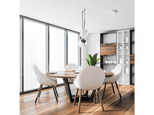 Charger l&#39;image dans la galerie, Une salle à manger avec une table ronde en bois, des chaises et une grande fenêtre.
