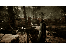 Charger l&#39;image dans la galerie, Un homme en robe noire marche dans une forêt. Des murs en ruine en arrière-plan.
