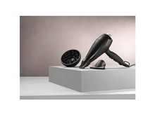 Charger l&#39;image dans la galerie, L&#39;arrière d&#39;un lave-vaisselle avec des tuyaux et une structure en mousse.
