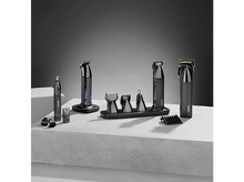 Charger l&#39;image dans la galerie, Une présentation d&#39;appareils de toilettage sur une surface grise. Un fond gris foncé.
