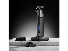 Charger l&#39;image dans la galerie, Tondeuse à cheveux Babyliss noire sur socle, deux peignes, fond gris.
