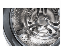 Charger l&#39;image dans la galerie, Gros plan de l&#39;intérieur du tambour d&#39;une machine à laver. Métal brillant avec perforations. Cadre en plastique gris.
