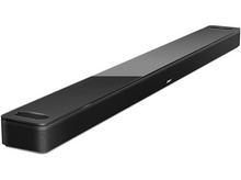 Charger l&#39;image dans la galerie, Une barre de son noire est positionnée en diagonale sur un fond blanc. La surface supérieure est brillante.
