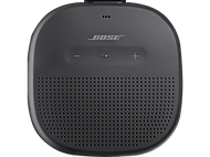 Enceinte portable Bose. Gris foncé, forme ovale avec boutons et grille de haut-parleur.