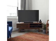 Charger l&#39;image dans la galerie, Un salon avec une télévision sur un meuble en bois, une fenêtre et un fauteuil bleu.
