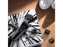 Charger l&#39;image dans la galerie, Un livre ouvert avec un rasoir, trois accessoires de tondeuse et des chaussures blanches.
