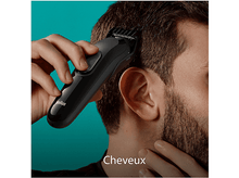 Charger l&#39;image dans la galerie, Une personne utilise une tondeuse à cheveux Braun noire, avec le mot &#39;Cheveux&#39; en bas.
