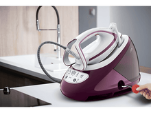 Charger l&#39;image dans la galerie, Un fer à repasser vapeur violet avec une poignée blanche et un outil de détartrage rouge.
