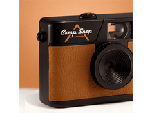 Charger l&#39;image dans la galerie, Un appareil photo noir et marron avec les mots &#39;Camp Snap&#39;. L&#39;objectif est noir et le corps a une texture marron semblable au cuir.
