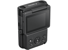 Charger l&#39;image dans la galerie, Appareil photo Canon noir avec écran rabattable et boutons. L&#39;objectif est en haut.
