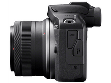Charger l&#39;image dans la galerie, Un boîtier d&#39;appareil photo noir avec un objectif fixé, vue latérale, isolé sur fond blanc.

