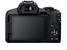 Charger l&#39;image dans la galerie, Un appareil photo noir avec un écran et des boutons. Il est sur une surface blanche.
