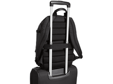 Charger l&#39;image dans la galerie, Sac à dos noir sur une valise, avec la poignée étendue.
