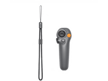 Charger l&#39;image dans la galerie, Une télécommande de drone grise avec une dragonne noire, sur une surface blanche.
